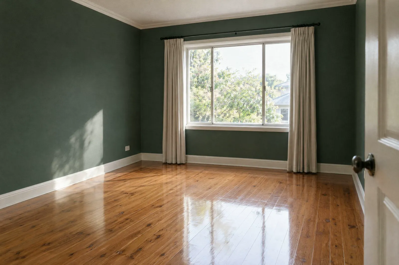 A spotless empty rental room, clean floorboards and daylight through the window